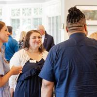 Jaime Guzior from Human Resources and another young woman talking with Dr, Robert Shorty